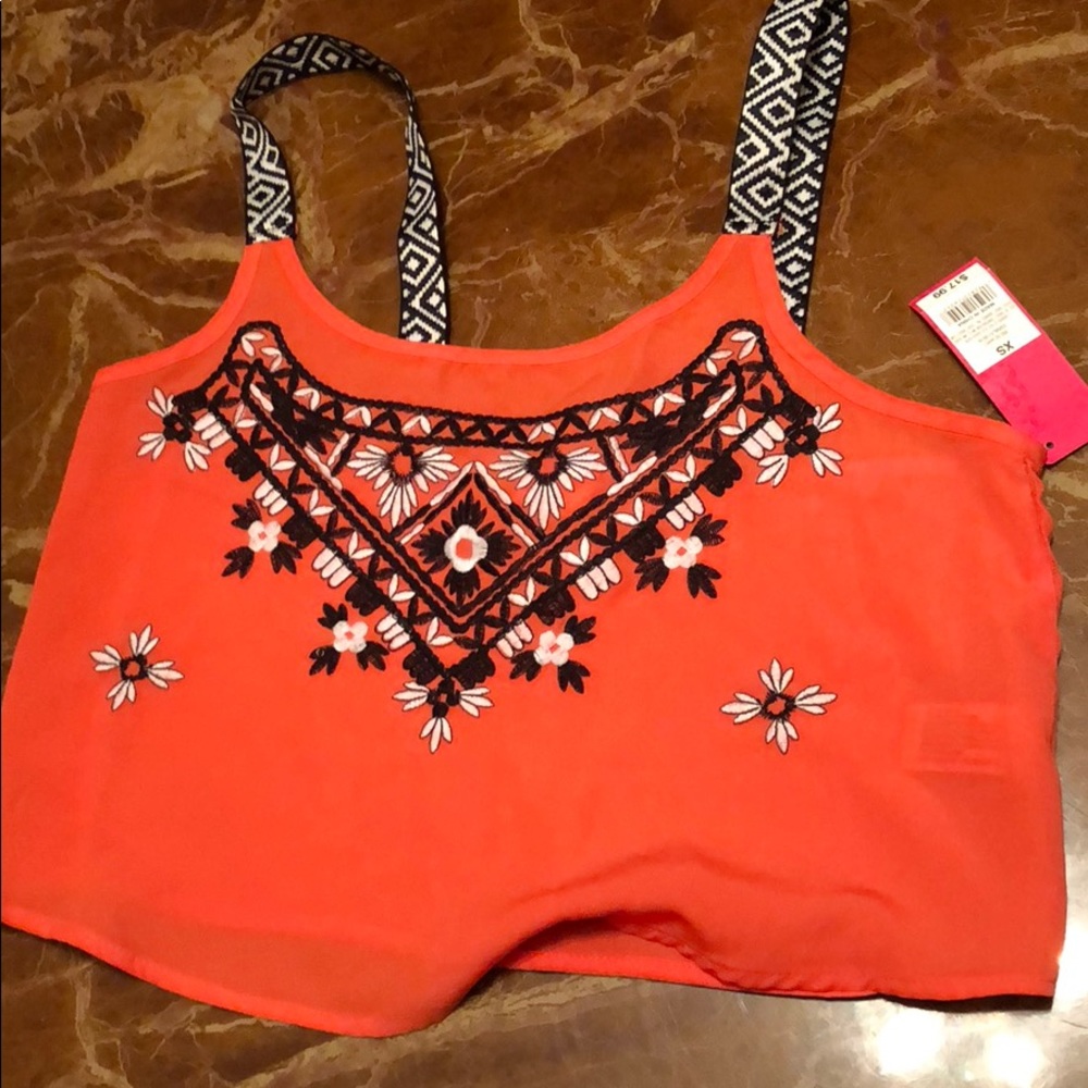 A pinkish orange crop top
